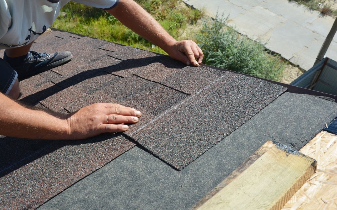 Roof repair contractor fixing missing shingles in Virginia