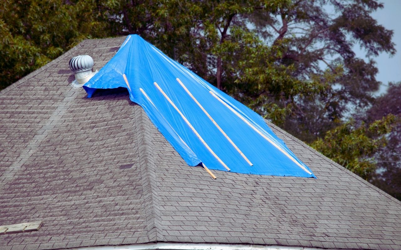 Emergency roof repair in Stafford, VA with 24/7 tarping during a heavy storm.
